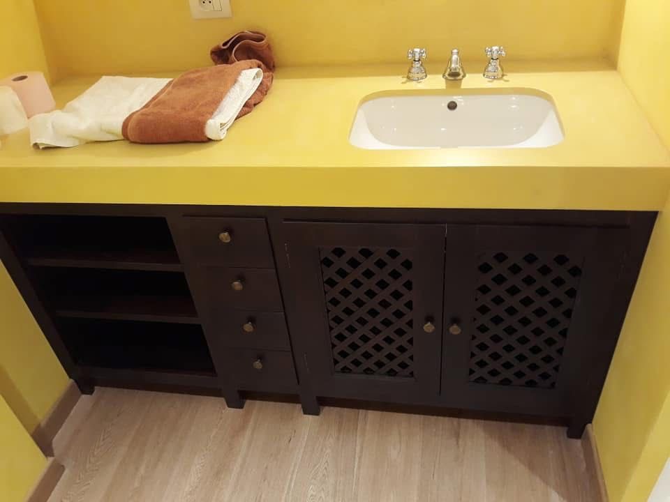 Mobile bagno in legno con top giallo e lavabo incassato